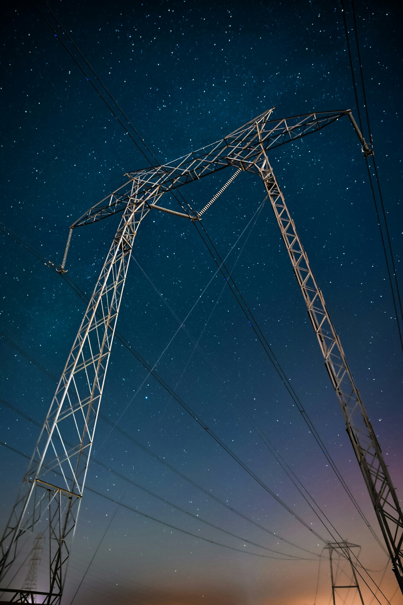 Power lines against a starry night sky