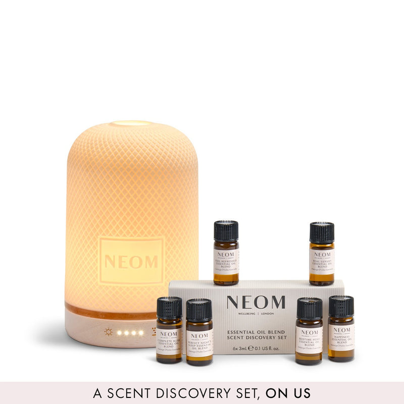 NEOM pod diffuser and a FREE essential oil discovery set on a white background