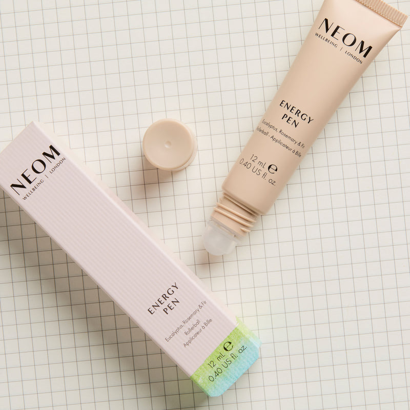 NEOM Energy Pen with packaging on a grid background