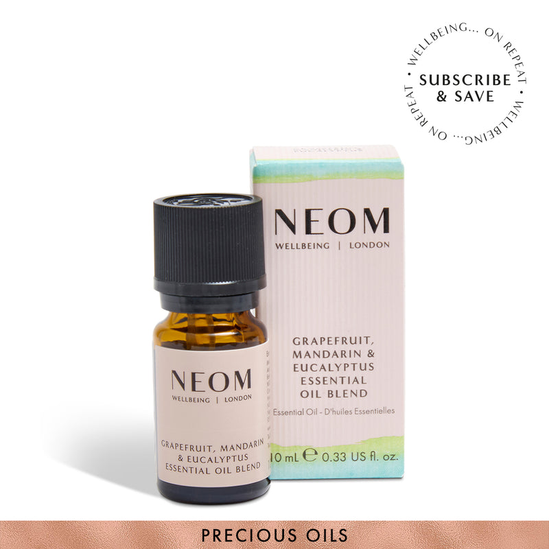 NEOM Grapefruit, mandarin and eucalyptus essential oil blend on a white background with subscription roundel