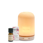 NEOM diffuser and essential oil bottle on a white background