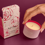 NEOM candle and packaging on a purple background
