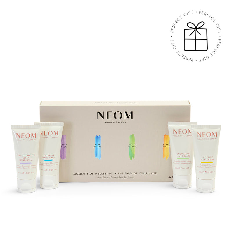 NEOM hand balm product set with four bottles and a box on a white background with a Perfect Gift roundel with a present