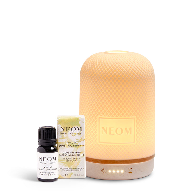 NEOM  diffuser, essential oil blend, and bottle on a white background