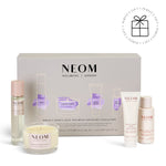 NEOM wellbeing collection with various products on a white background with a Perfect Gift roundel with a present