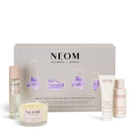 NEOM sleep wellbeing collection with various products on a white 