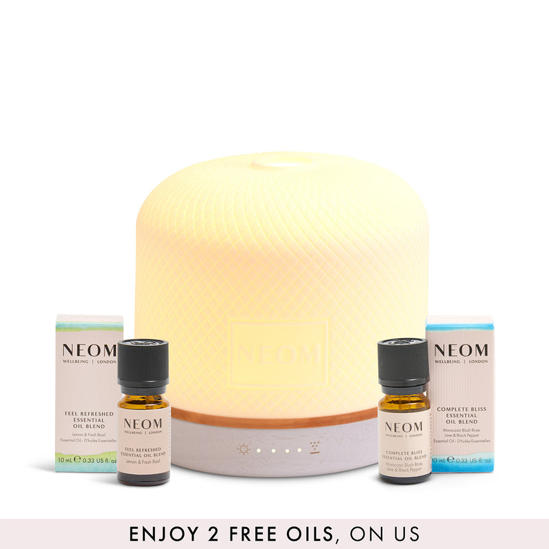 NEOM pod luxe diffuser and 2 FREE essential oils on a white background