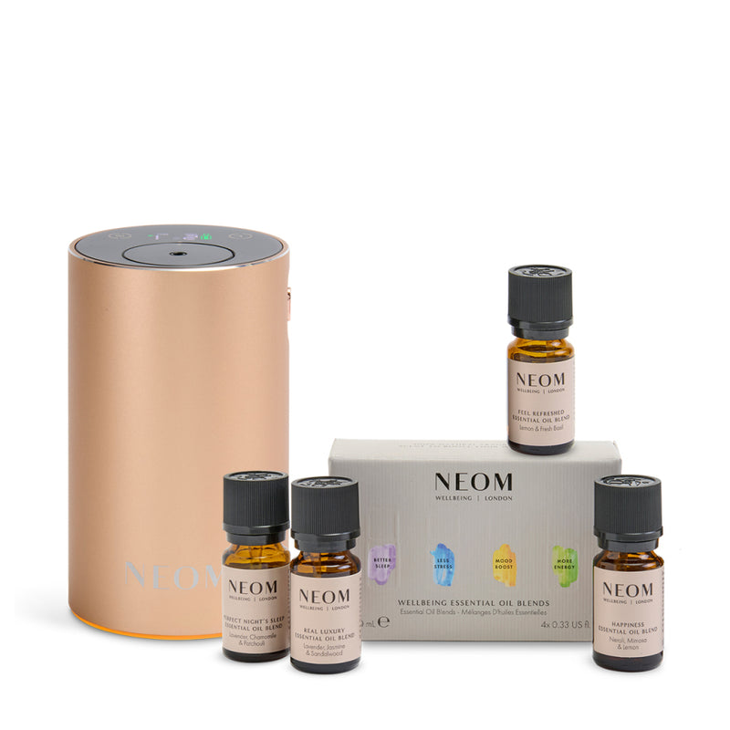 NEOM pod mini plus in rose gold and essential oil blend set on a white background