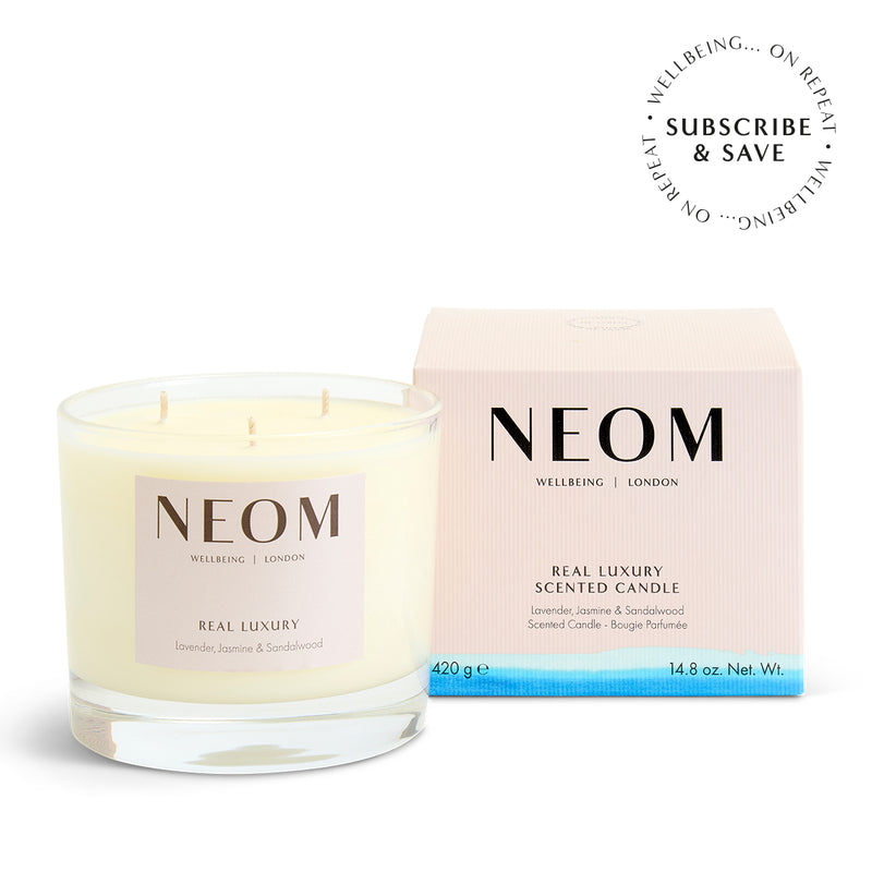 NEOM Real luxury 3 Wick Candle on a white background with subscription roundel