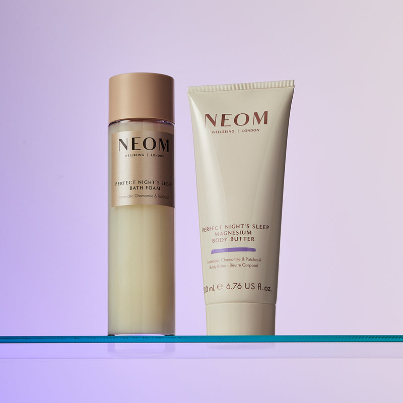 NEOM skincare products on a gradient purple background