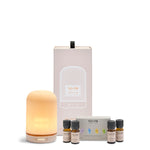 NEOM electric pod diffuser and essential oils with packaging on a white background
