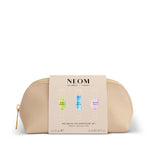 NEOM wellbeing pen discovery set in a gold pouch on a white background